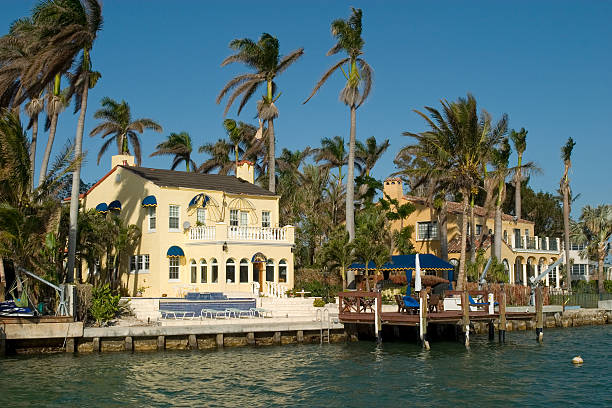 A Luxury White Yacht by a Miami Mansion