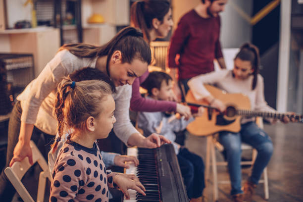 Children in music school Group of people, teachers and children in music school, learning to play music instruments together. juvenile musician stock pictures, royalty-free photos & images