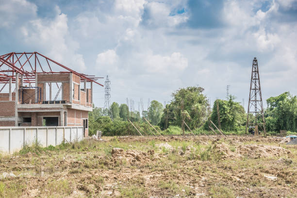 istock Residential new house building at construction site with clouds and blue sky 929304992