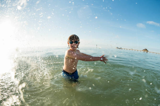 Happy brother and sister embrace each other in the water