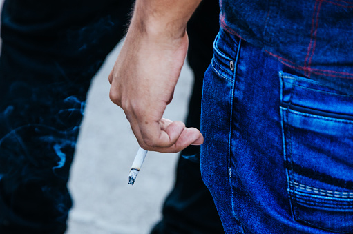 A young man with a cigar in his hand