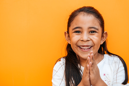 Portrait of a little girl praying