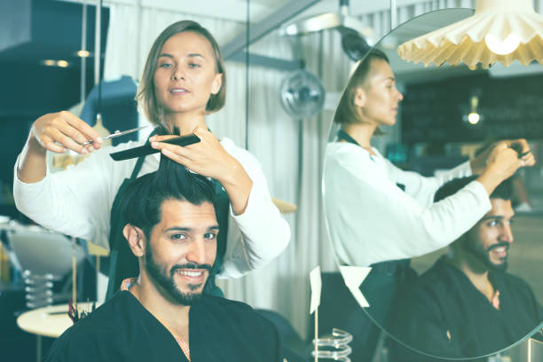 istock hairdresser working with scissors and comb 929335452