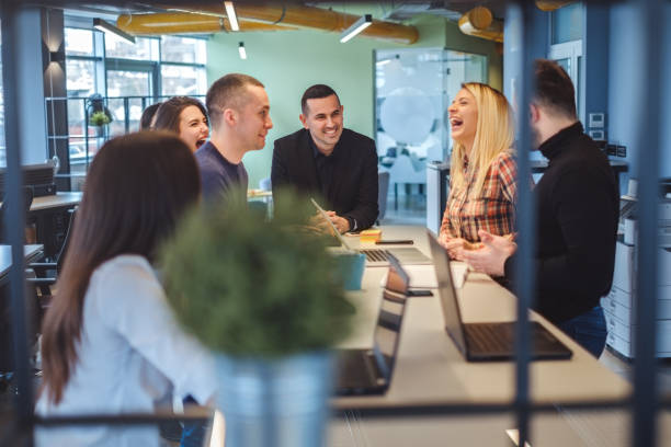 istock Coworkers laughing at the office meeting 929338838