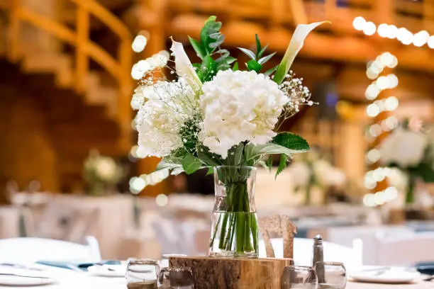 Winter wedding reception with beautiful flower centerpieces and number seating assignment tags in Oregon.