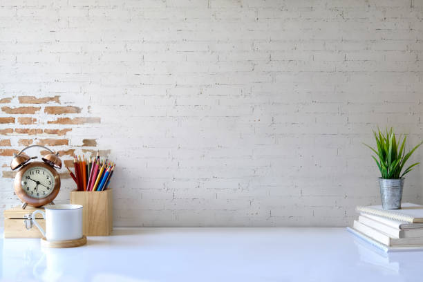 istock White desk table with copy space, supplies and coffee mug. Front view workspace and copy space 929368276