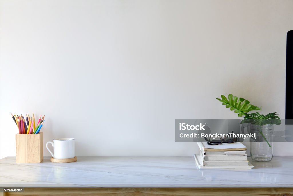 Contemporary workspace with books, colour pencils, gadgets and supplies. workspace and copy space Desk Stock Photo