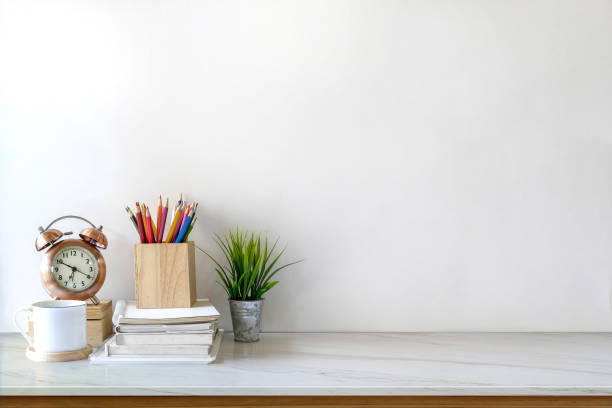 istock White desk table with copy space, supplies and coffee mug. Front view workspace and copy space 929368596