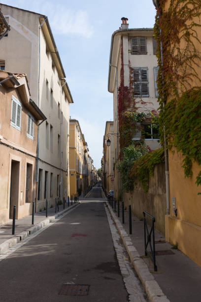 istock Narrow Street Lined with Stucco Buildings 929377312