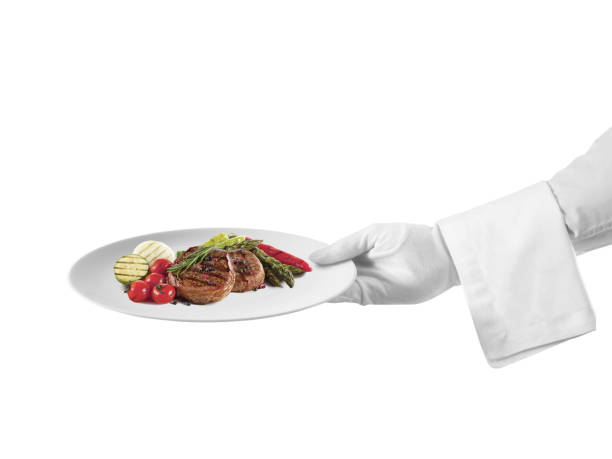 스테이크 요리를 제공 하는 웨이터 - first class butler white glove 뉴스 사�진 이미지