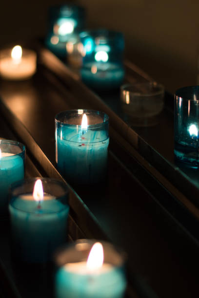 istock Lit Votive Candles in Low Light 929383980