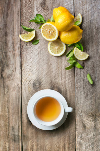 istock A cup of lemon tea and lemons on rustic wooden background. 929404002
