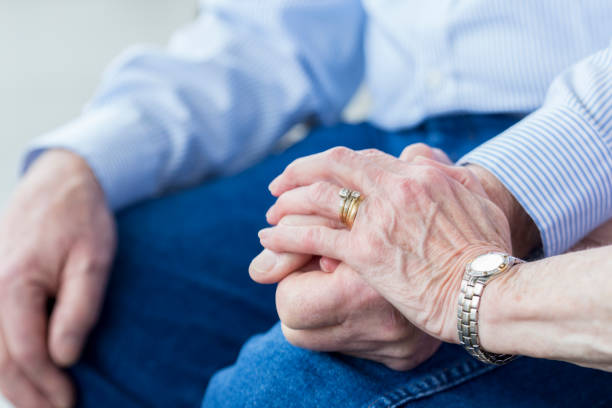 istock Unrecognizable senior woman holds her husband's hand 929424742