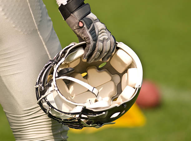 istock Football Helmet in hand 92942883