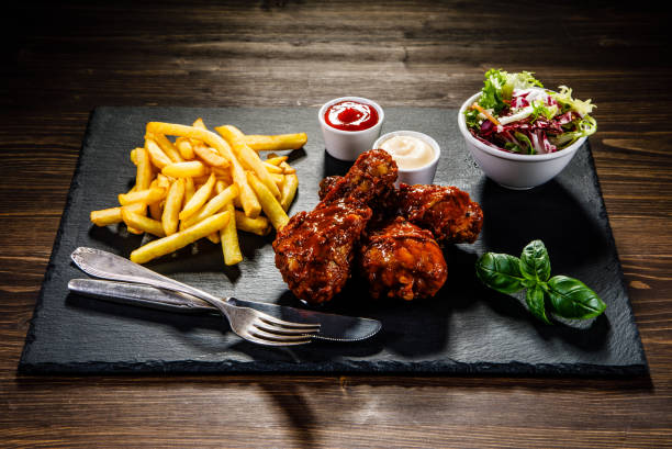 istock Fried chicken drumstics with French fries 929435742
