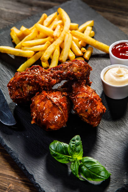 istock Fried chicken drumstics with French fries 929436150