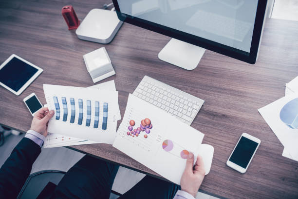 istock Working Businessman Analyzing Charts Reports in the Office 929443734