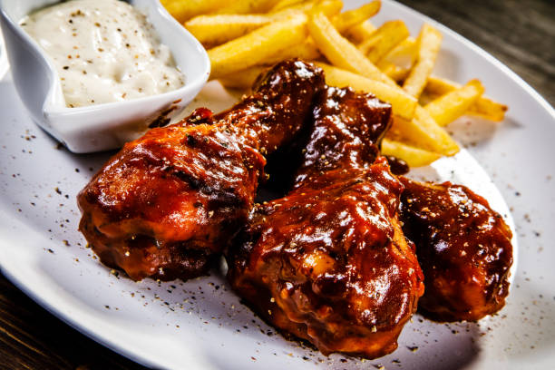 istock Fried chicken drumstics with French fries 929444096