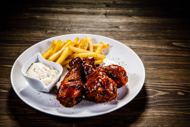 istock Fried chicken drumstics with French fries 929444214