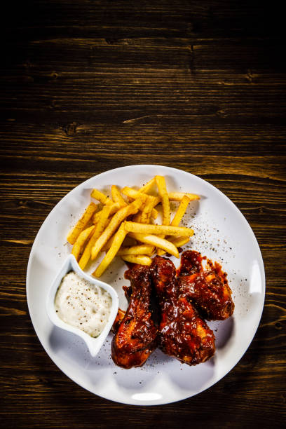 istock Fried chicken drumstics with French fries 929444432