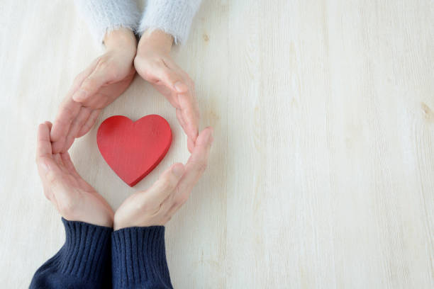 istock Heart surrounded by man and woman's hand 929453636