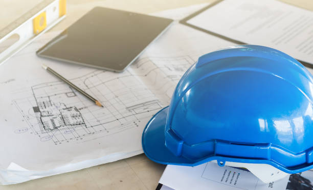 istock The safety helmet and the blueprint on table at construction site 929468664