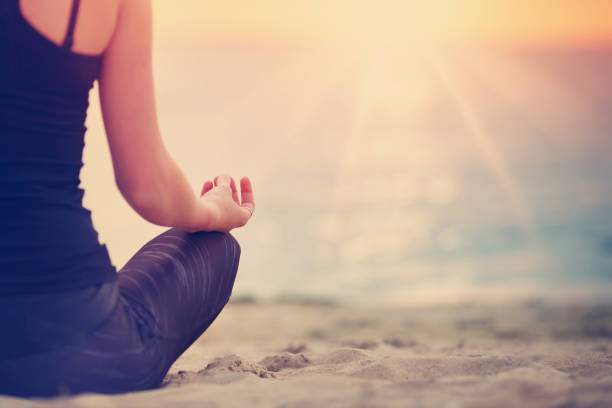 istock young woman sitting on the beach 929472996