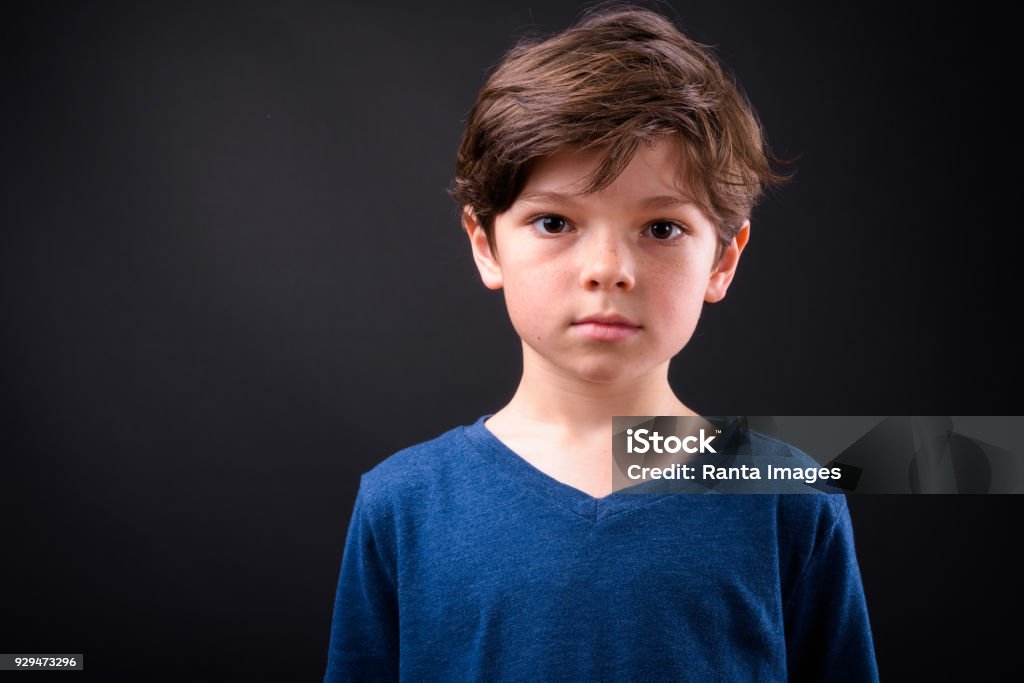 Face Of Cute Boy Against Black Background Studio Shot Of Cute Boy Against Black Background Child Stock Photo