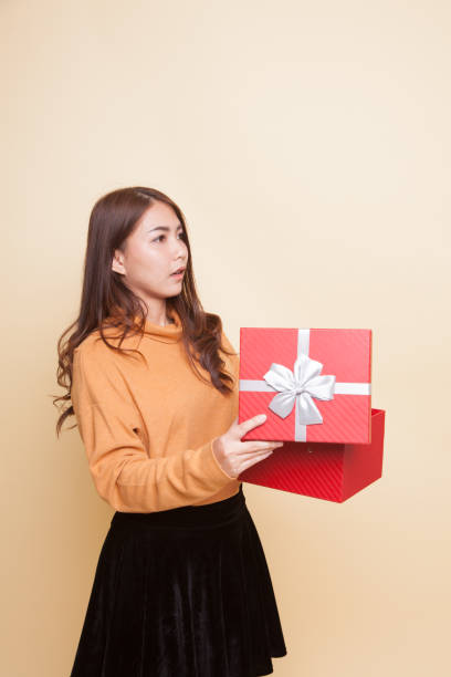 istock Young Asian woman open a gift box. 929473824