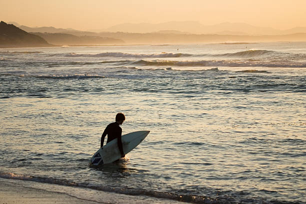 istock silhouette of surfer at sunset 92947512