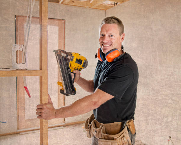 istock attractive and confident constructor carpenter or builder man working wood with electric drill at industrial construction site in installation and renovation work industry 929480328