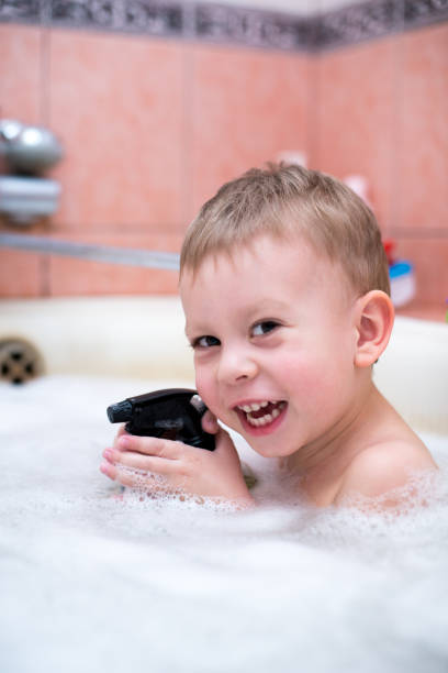 istock the child is bathing in the bathroom 929483016