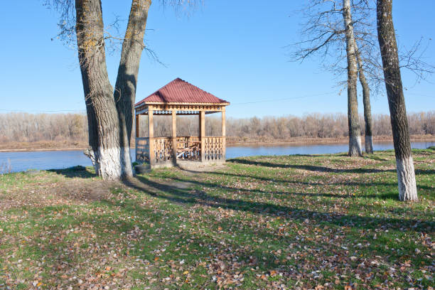 istock Wooden gazebo on the bank 929485574