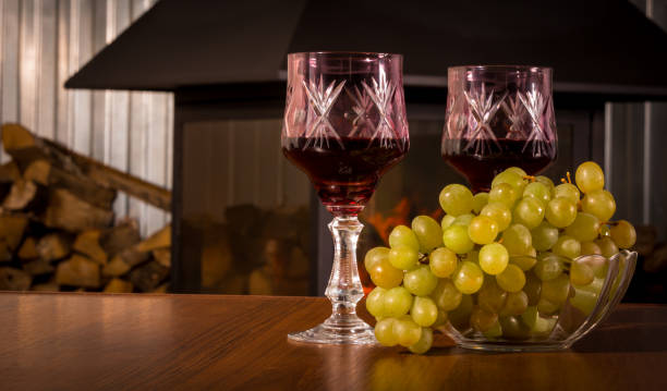 istock Wine and grapes on the background of the fireplace 929486794