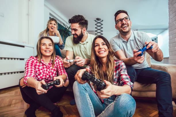istock Group of friends play video games together. 929487270