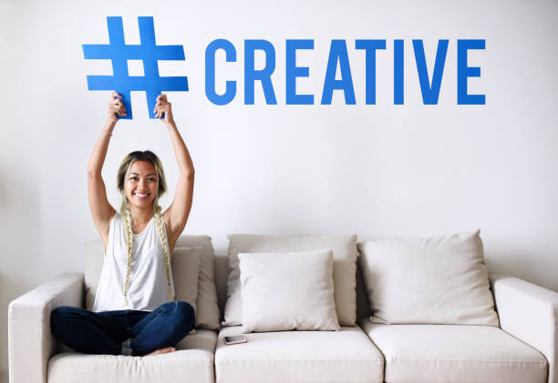 Woman on a couch holding a word