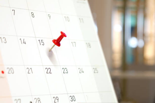 istock Embroidered red pins on a calendar on the 15th with selective focus 929489658