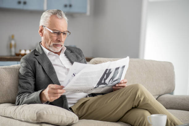 istock Handsome male person reading interesting article 929490382