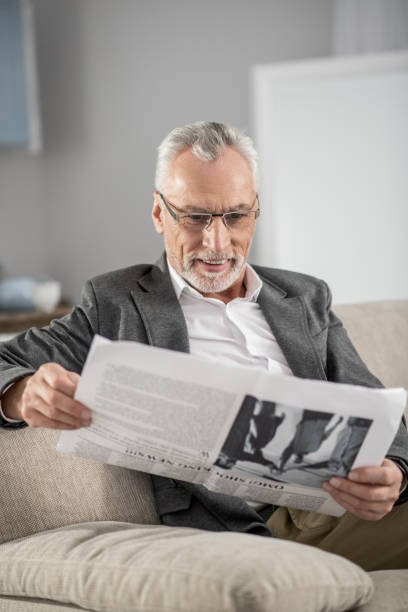 istock Positive delighted businessman reading news 929490460