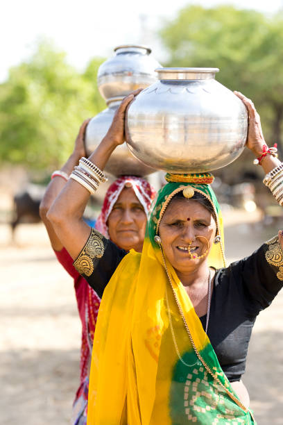 istock Indian women carrying water pots on head 929493238