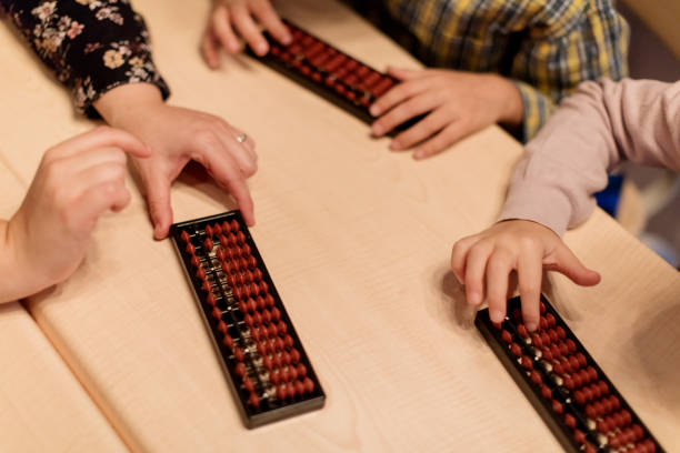 istock Close-up of school children using abacus 929495098