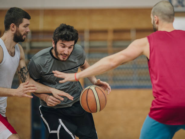 istock Determined basketball player making an effort while dribbling his rivals. 929498062