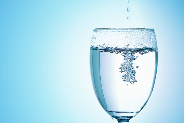 istock Pour drinking water into the glass with copy space 929498950