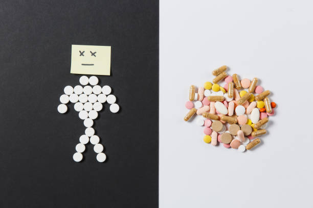 istock Medication white colorful round tablets arranged abstract on white black background. Human sad, aspirin, capsule pills design. Treatment choice healthy lifestyle concept. Copy space for advertisement. 929503206