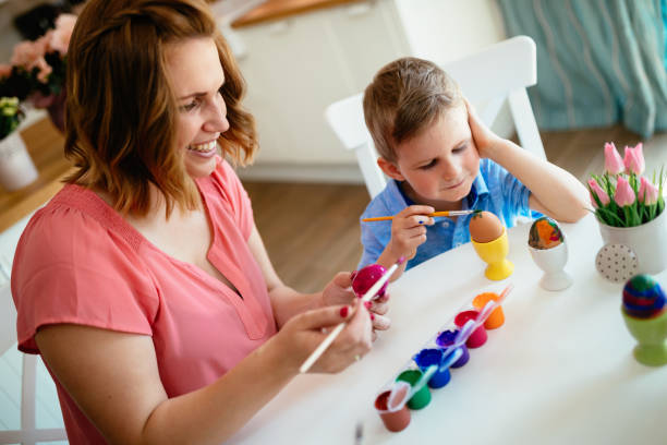 istock Happy Family Painting Easter Eggs 929506072