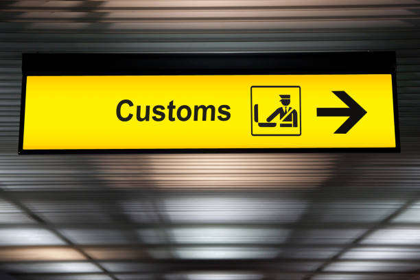 空港税関空港国際線ターミナルで天井からぶら下がっている矢印アイコンと記号を宣言します。税関のインポートの宣言し、コンセプトをエクスポート - customs ストックフォトと画像