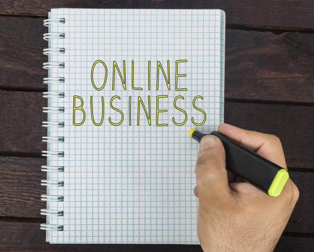 istock male hand is writing Online business on a notepad 929514830