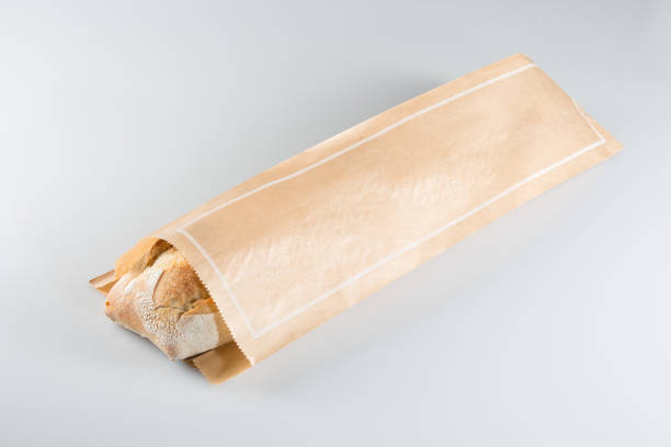 Baguette paper bag on white background french baguette kraft paper packaging bread bakery baguette french culture stock pictures, royalty-free photos & images