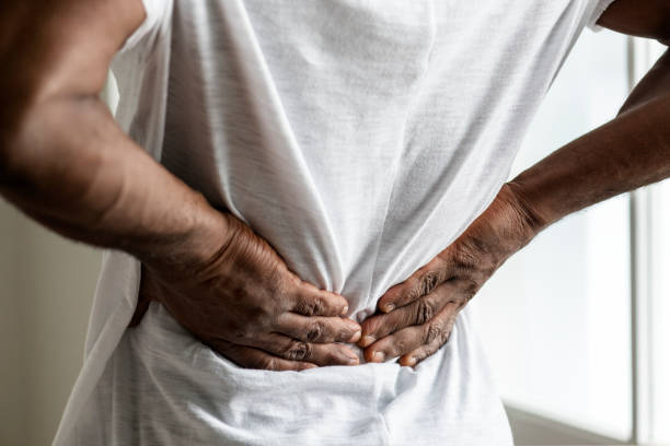 black man suffering back pain - back rear view pain backache imagens e fotografias de stock