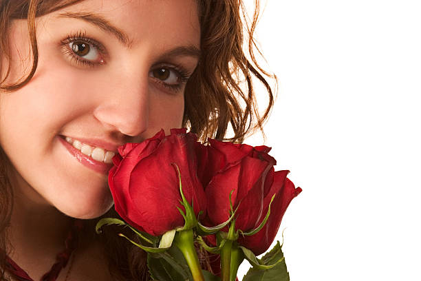 Valentine's day present. Happy young woman smelling bouquet of roses flowers from husband on kitchen. Women's day. Surprise from boyfriend